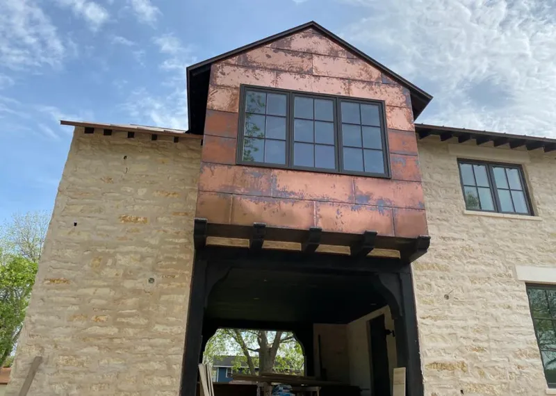 Copper metal panel facade on a stone building for Skylight Installation in Oak Brook