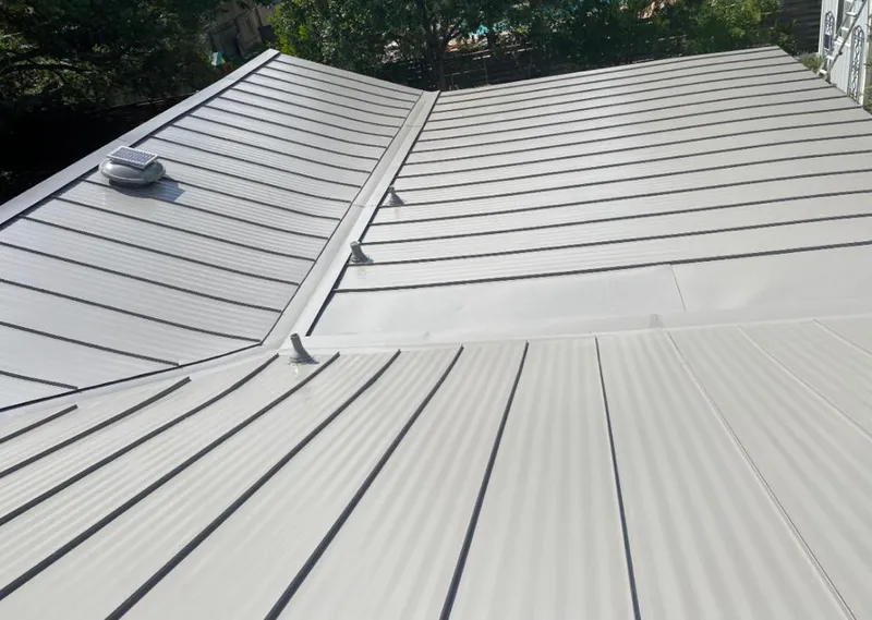 Solar attic fan installed on a metal roof for Roof Ventilation in Oak Brook